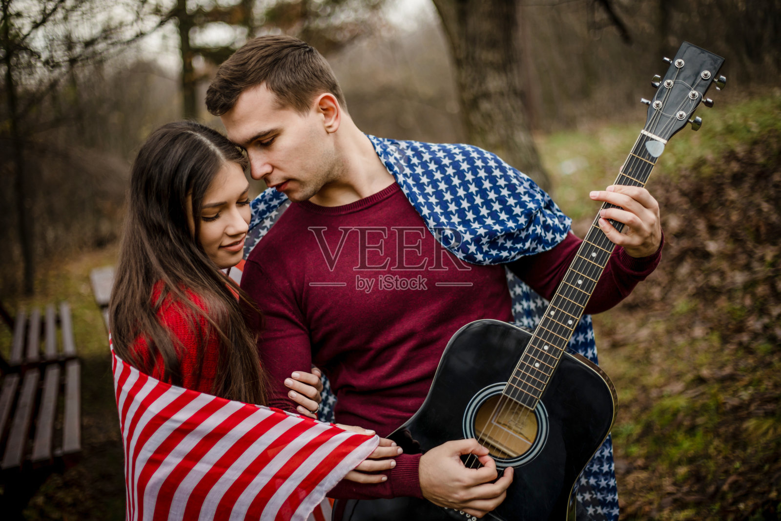 一对情侣在公园玩吉他照片摄影图片