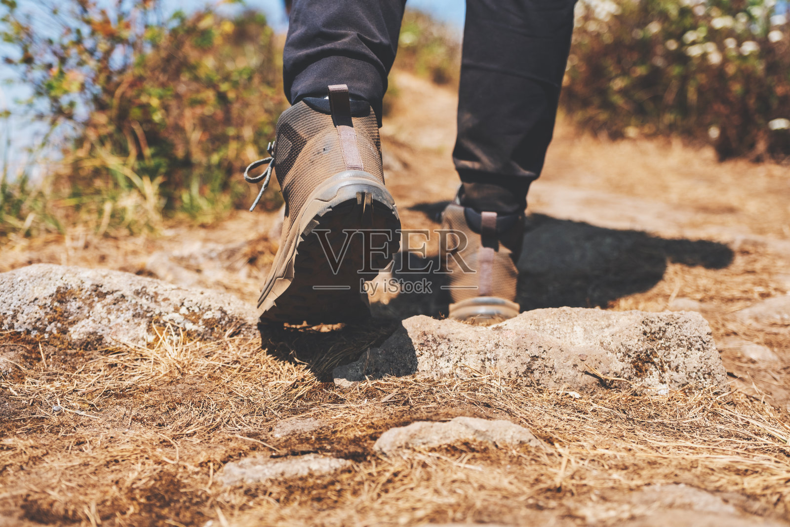 穿登山靴在山顶徒步旅行的女人照片摄影图片