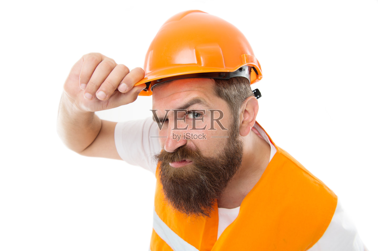 残忍和勤奋。野蛮的工人被白人孤立。长着胡子，一脸凶相的男人。建筑工人或建筑商应戴上安全帽及安全背心。残酷的工作照片摄影图片