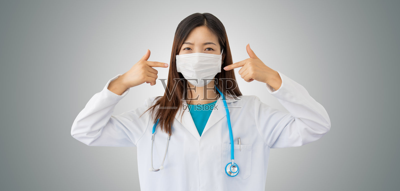 亚洲年轻女医生，介绍防护口罩、预防季节性流感和冠状病毒流行的安全措施照片摄影图片