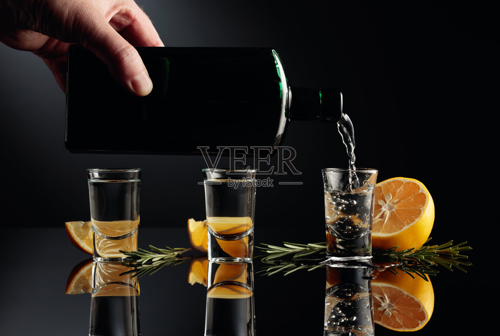 杜松子酒，柠檬和迷迭香，黑色背景。照片摄影图片