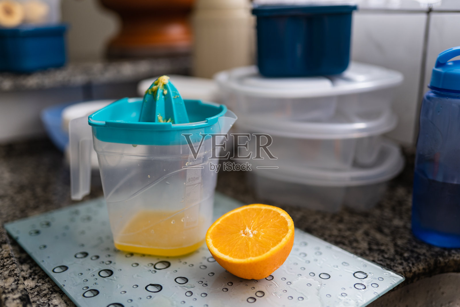 水槽里有切片橙和塑料榨汁机照片摄影图片