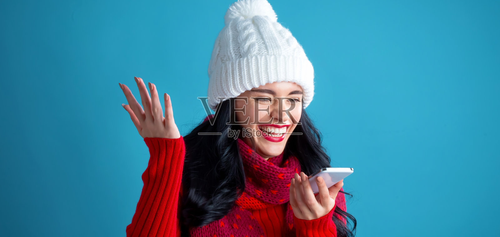 一个用手机玩圣诞主题的年轻女人照片摄影图片