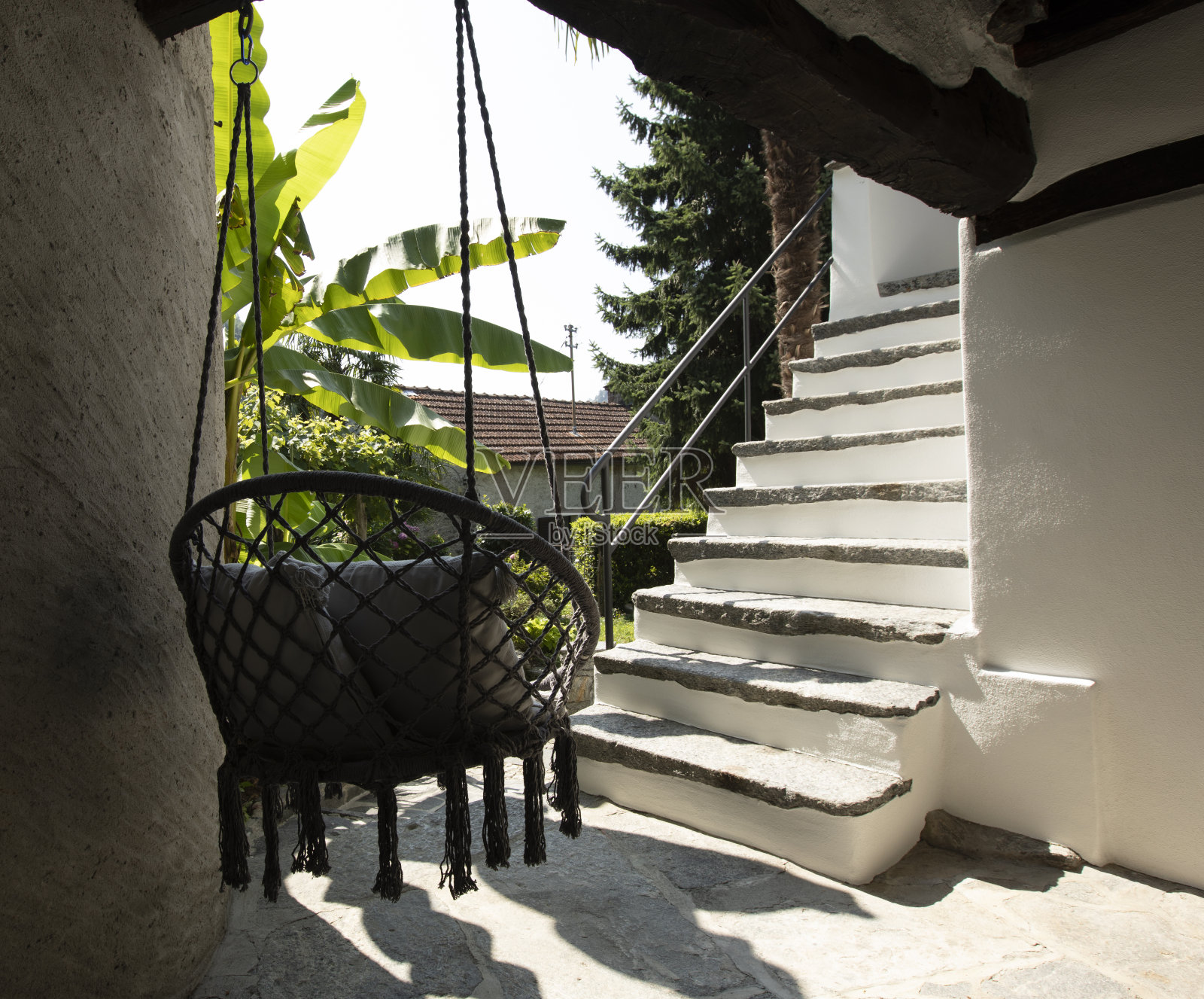 瑞士住宅入口处悬挂的漂亮的圆形椅子或扶手椅。照片摄影图片