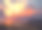 日落时分，海滩上的人看着摩天大楼，素材图片